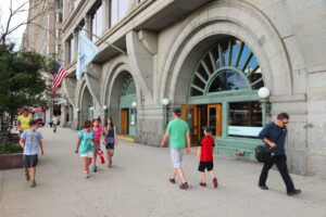 CHICAGO, USA - JUNE 27, 2013: People walk by Roosevelt University in Chicago. Roosevelt University is a private educational institution founded in 1945.