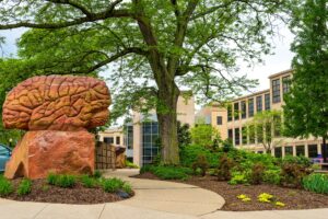 KENT, OH - MAY 21, 2018: The secluded "Brain Plaza" on the KSU campus is anchored by a sculpture of a giant brain and lined with shelves of books carved in stone.