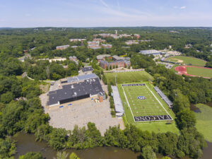 WALTHAM, MA, USA - JUL. 9, 2019: Bentley University Dana Athletic Center and Bentley Falcons football court aerial view in city of Waltham, Massachusetts MA, USA.